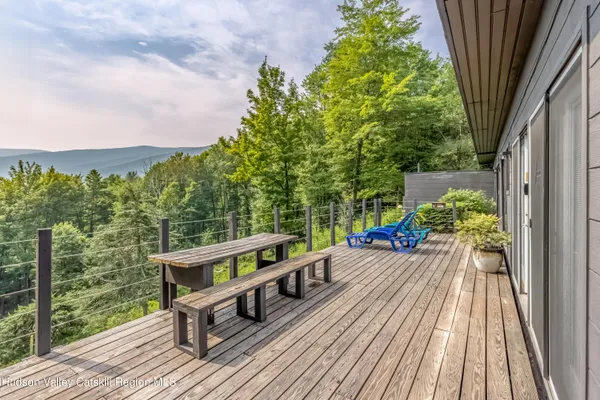 a view of balcony with wooden floor and outdoor seating