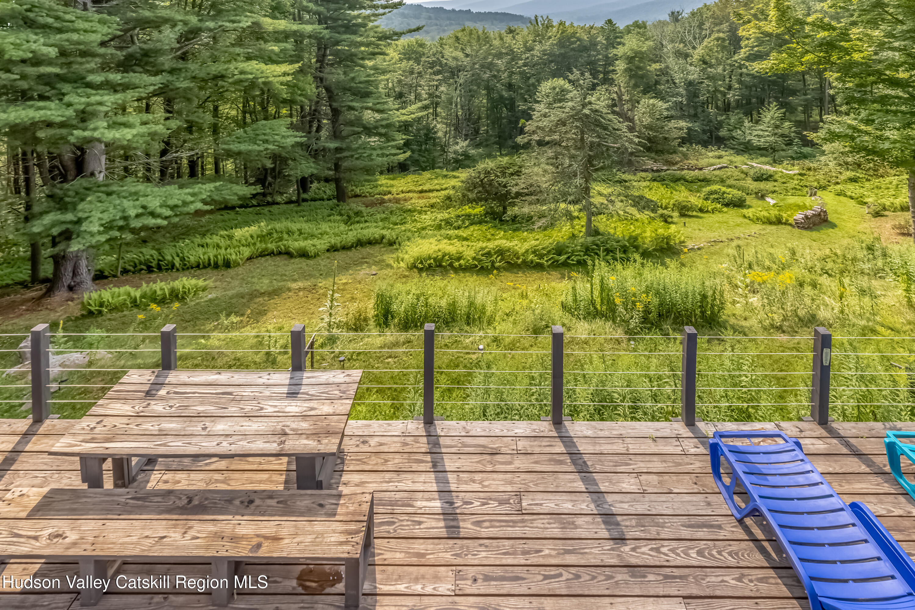 166 Todd Hill Road, Unit 166 West Kill, NY 12492 - Photo 10 of 42 a view of a patio with chairs next to a yard