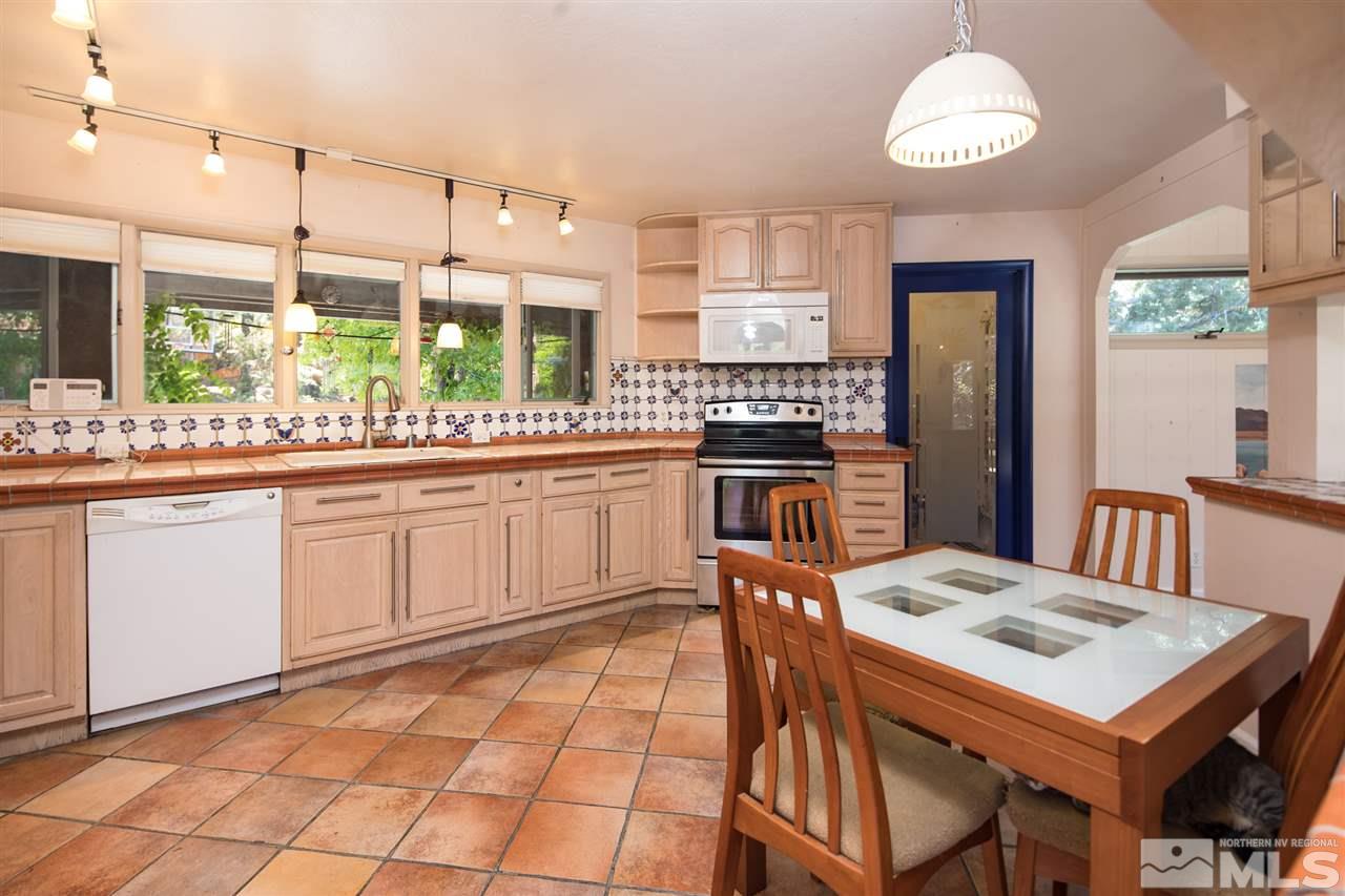 4321 Bridle Way Reno, NV 89519 - Photo 16 of 25 a kitchen with a stove a table and chairs in it