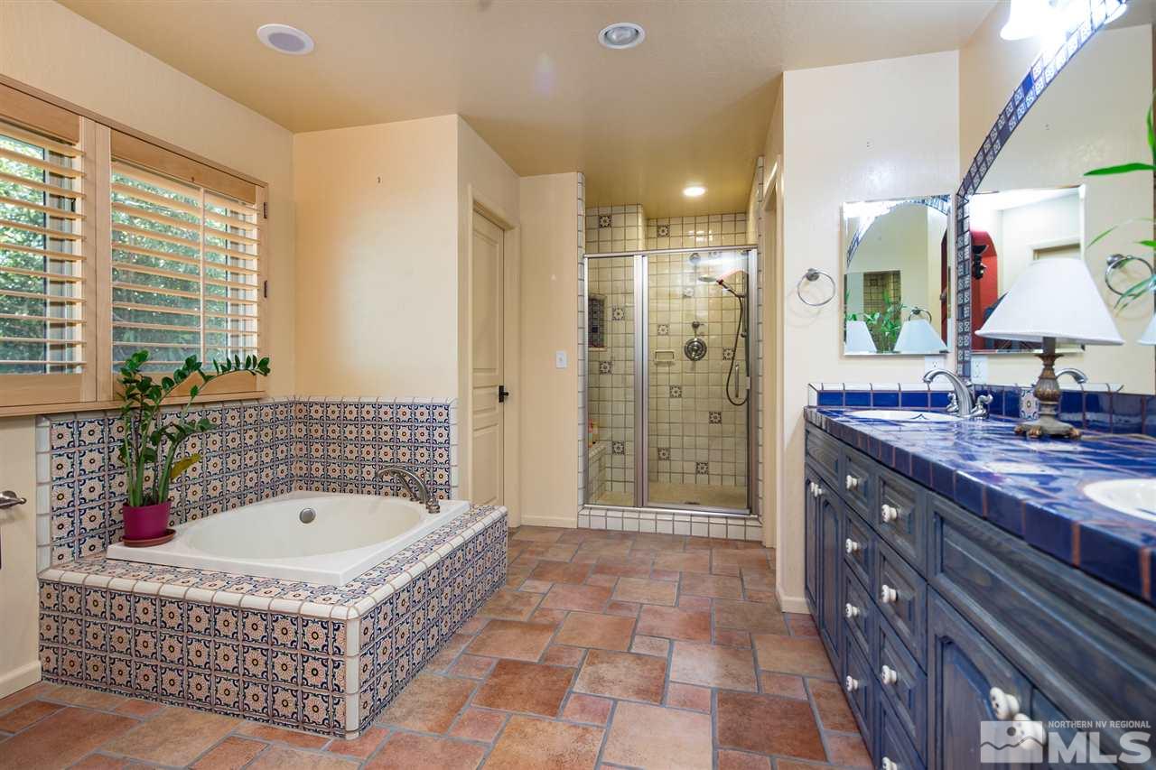 4321 Bridle Way Reno, NV 89519 - Photo 20 of 25 a bathroom with a tub a sink shower and a mirror