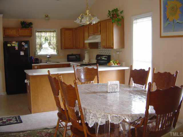 4420 Canadian Court Raleigh, NC 27616 - Photo 2 of 5 a view of a dining room with furniture and chandelier