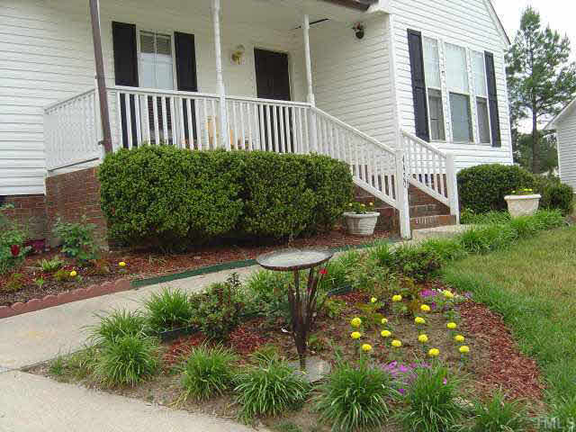 4420 Canadian Court Raleigh, NC 27616 - Photo 5 of 5 a view of a house with a yard and potted plants