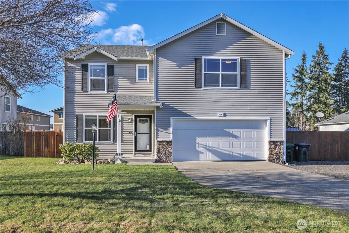 a front view of a house with a yard and garage
