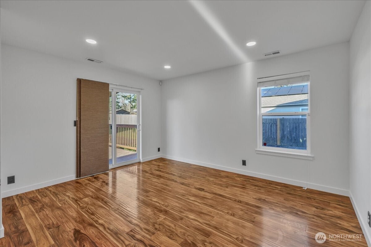 414 Easy Street Rainier, WA 98576 - Photo 22 of 38 a view of an empty room with wooden floor and a window