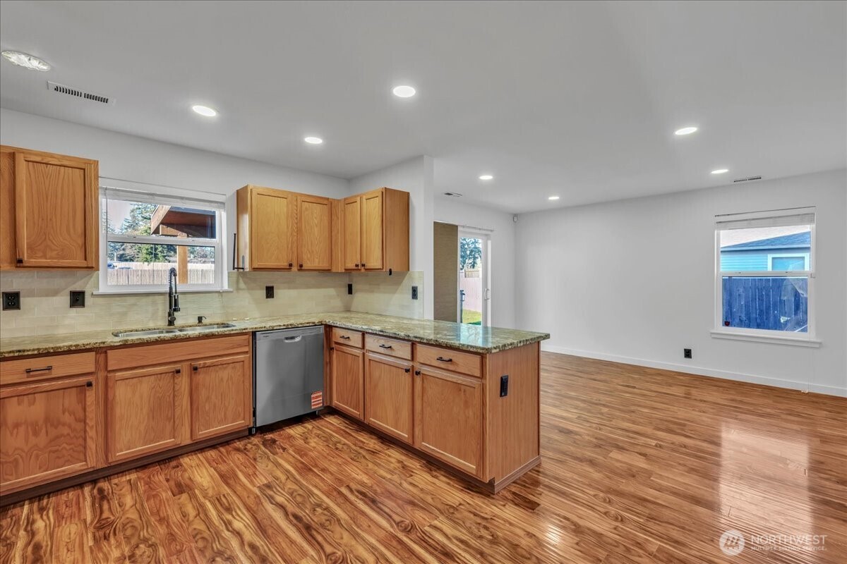414 Easy Street Rainier, WA 98576 - Photo 3 of 38 a kitchen with stainless steel appliances granite countertop a sink and cabinets