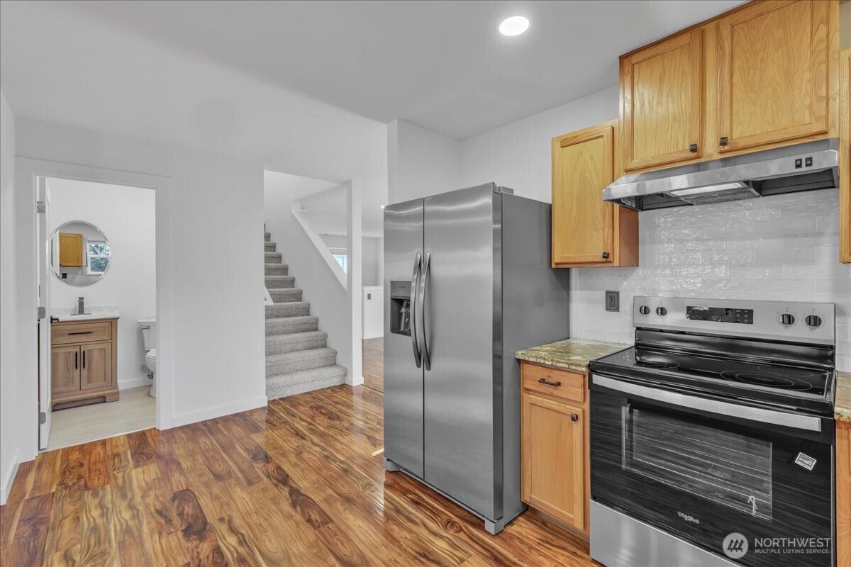 414 Easy Street Rainier, WA 98576 - Photo 4 of 38 a kitchen with granite countertop a stove and a refrigerator