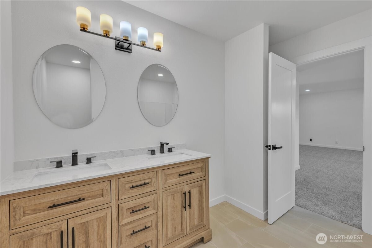 414 Easy Street Rainier, WA 98576 - Photo 8 of 38 a bathroom with a double vanity sink and a mirror