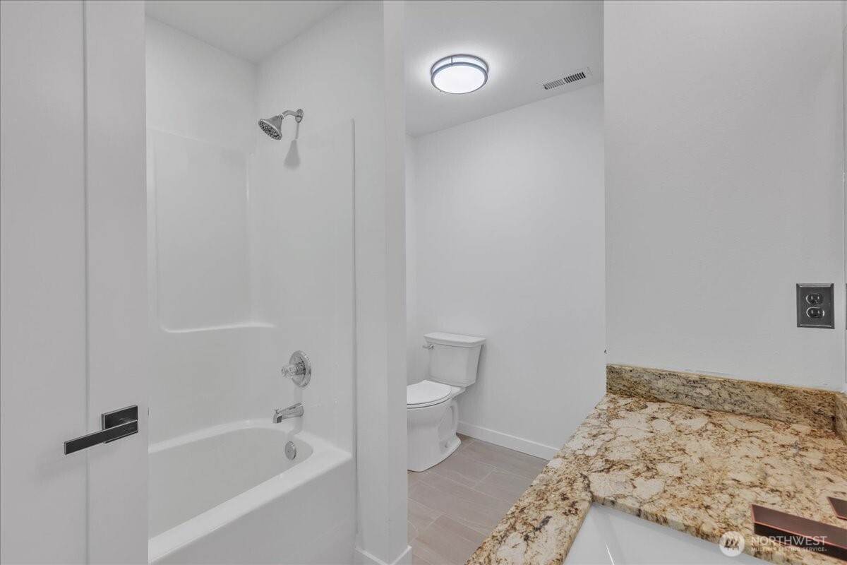 414 Easy Street Rainier, WA 98576 - Photo 10 of 38 a bathroom with a bathtub and toilet