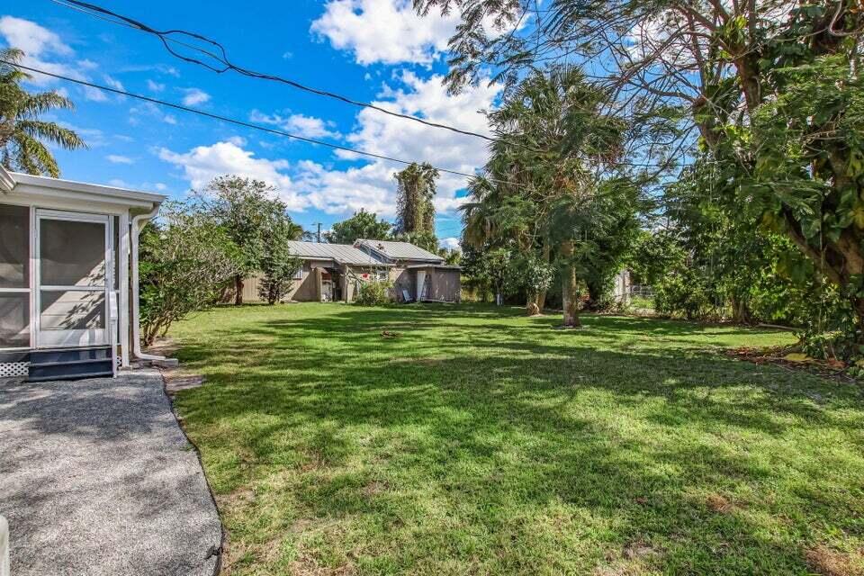 4228 Southeast Bayview Street Stuart, FL 34997 - Photo 2 of 3 a view of a house with a yard