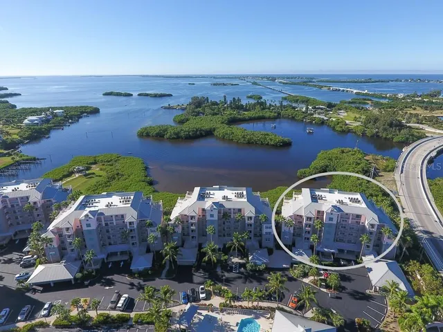 an aerial view of a house with a garden and lake view