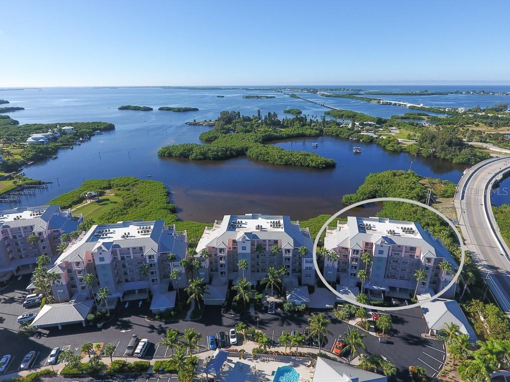 an aerial view of a house with a garden and lake view