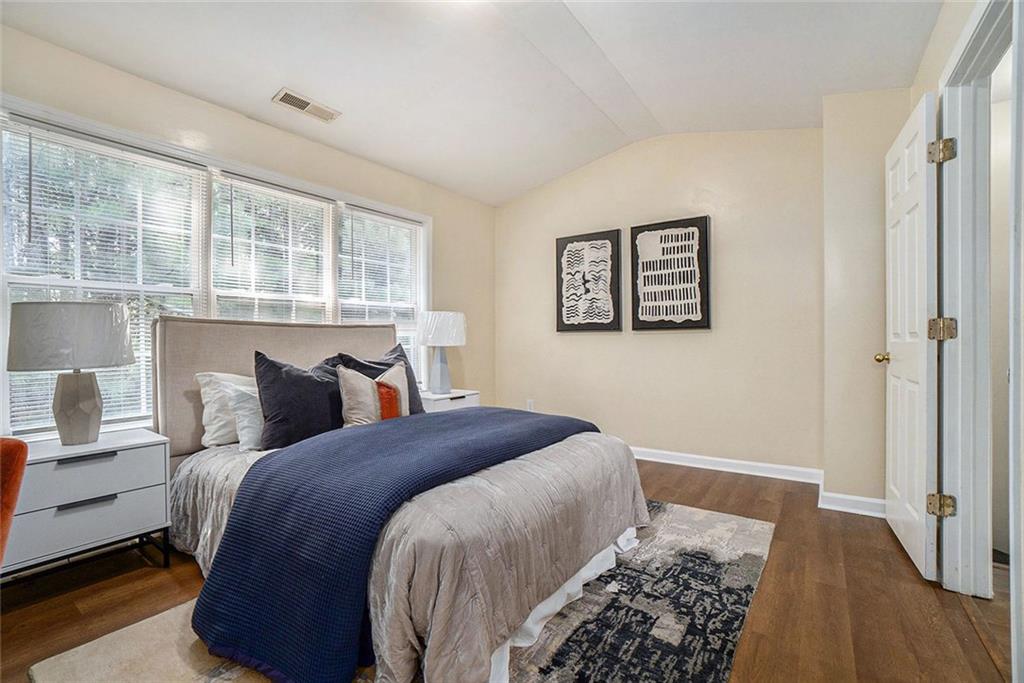 734 Celeste Lane, Unit 84 Atlanta, GA 30331 - Photo 14 of 34 a bedroom with bed and wooden floor