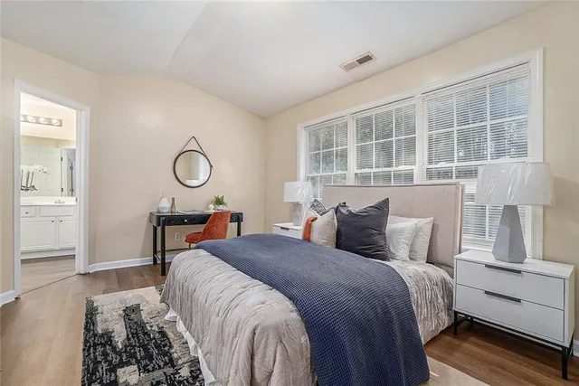 a bedroom with a large bed and a window