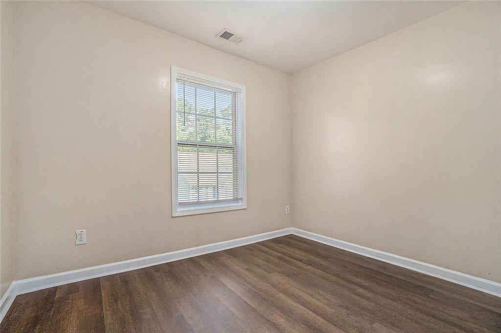 734 Celeste Lane, Unit 84 Atlanta, GA 30331 - Photo 27 of 34 an empty room with wooden floor and windows