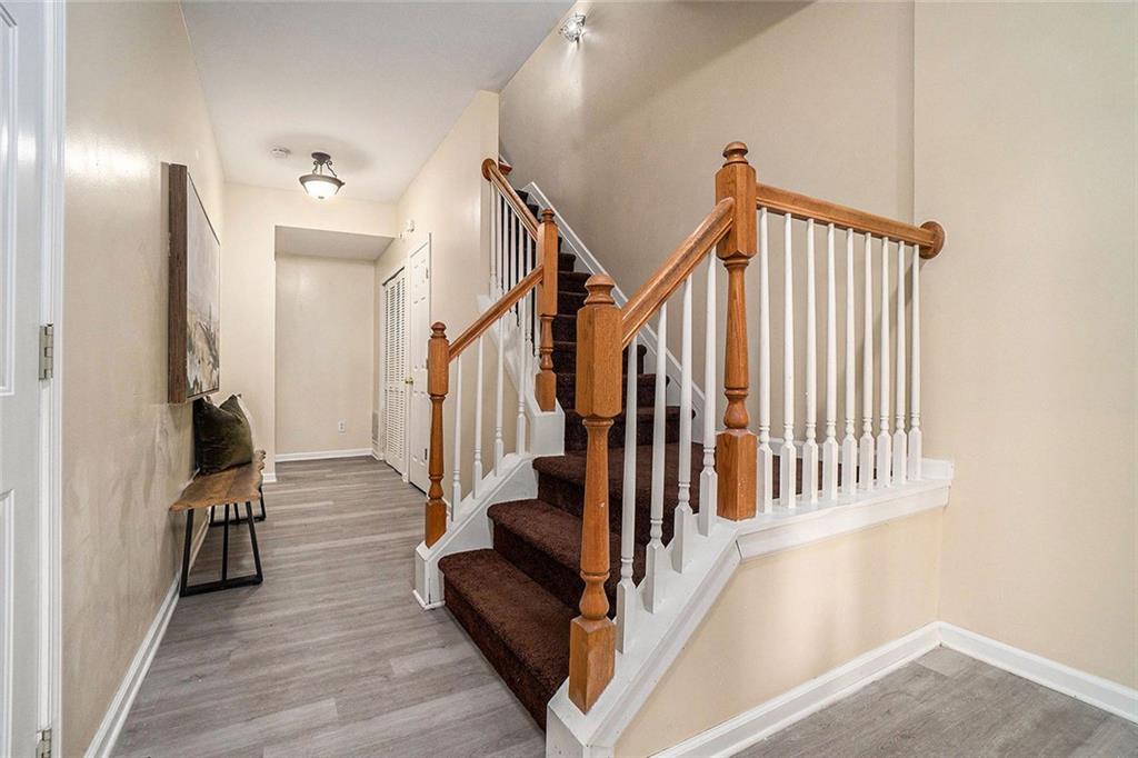 734 Celeste Lane, Unit 84 Atlanta, GA 30331 - Photo 3 of 34 a view of a hallway with wooden floor and staircase