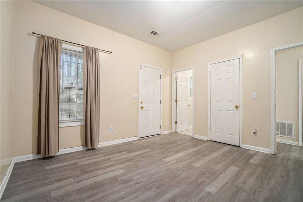 734 Celeste Lane, Unit 84 Atlanta, GA 30331 - Photo 4 of 34 a view of an empty room with wooden floor and windows