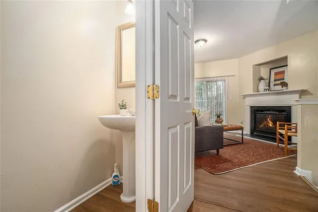a living room with furniture a fireplace and a large window