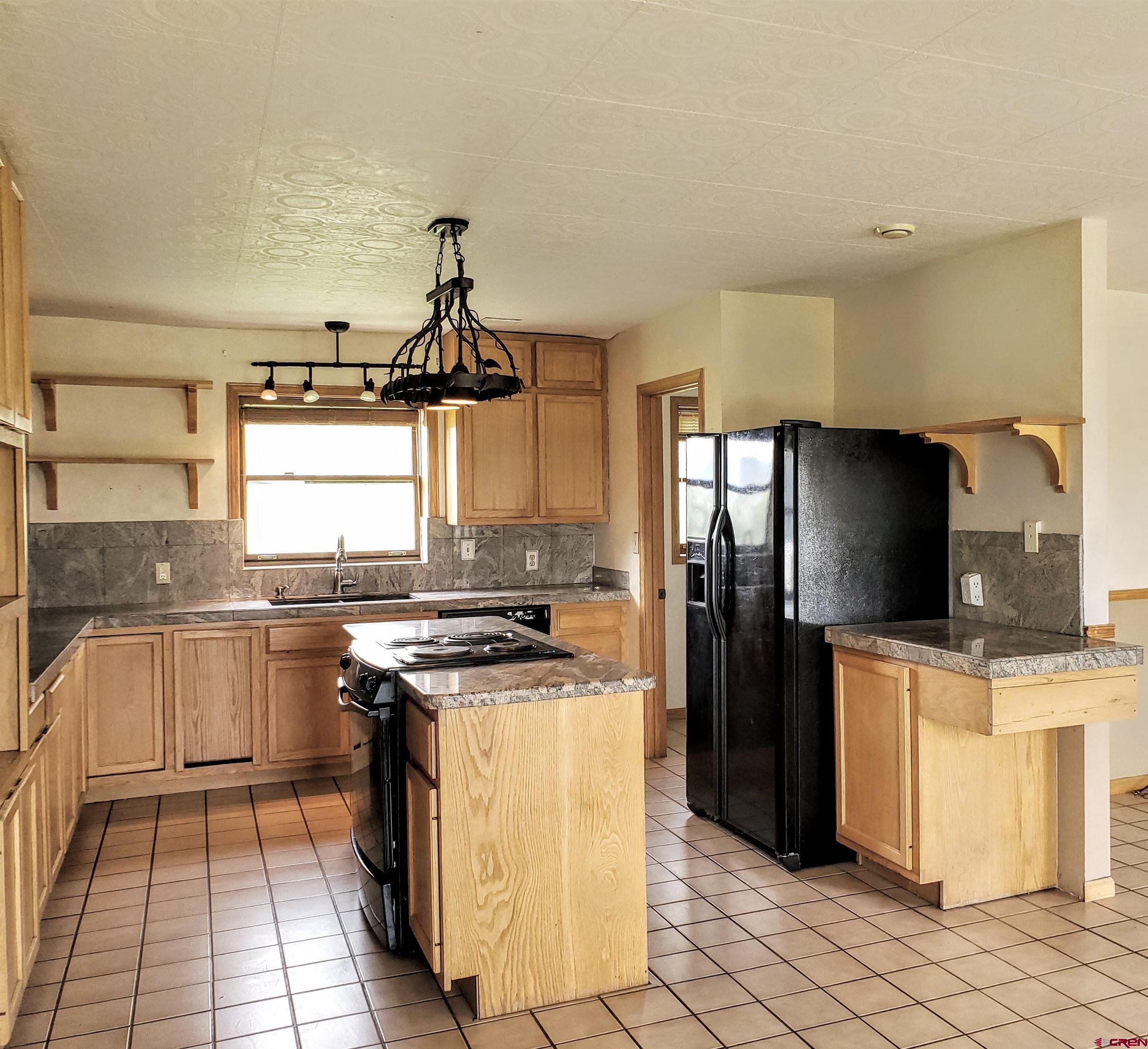 79 Cedar Circle Durango, CO 81303 - Photo 16 of 30 a kitchen with stainless steel appliances granite countertop a stove a sink and a refrigerator
