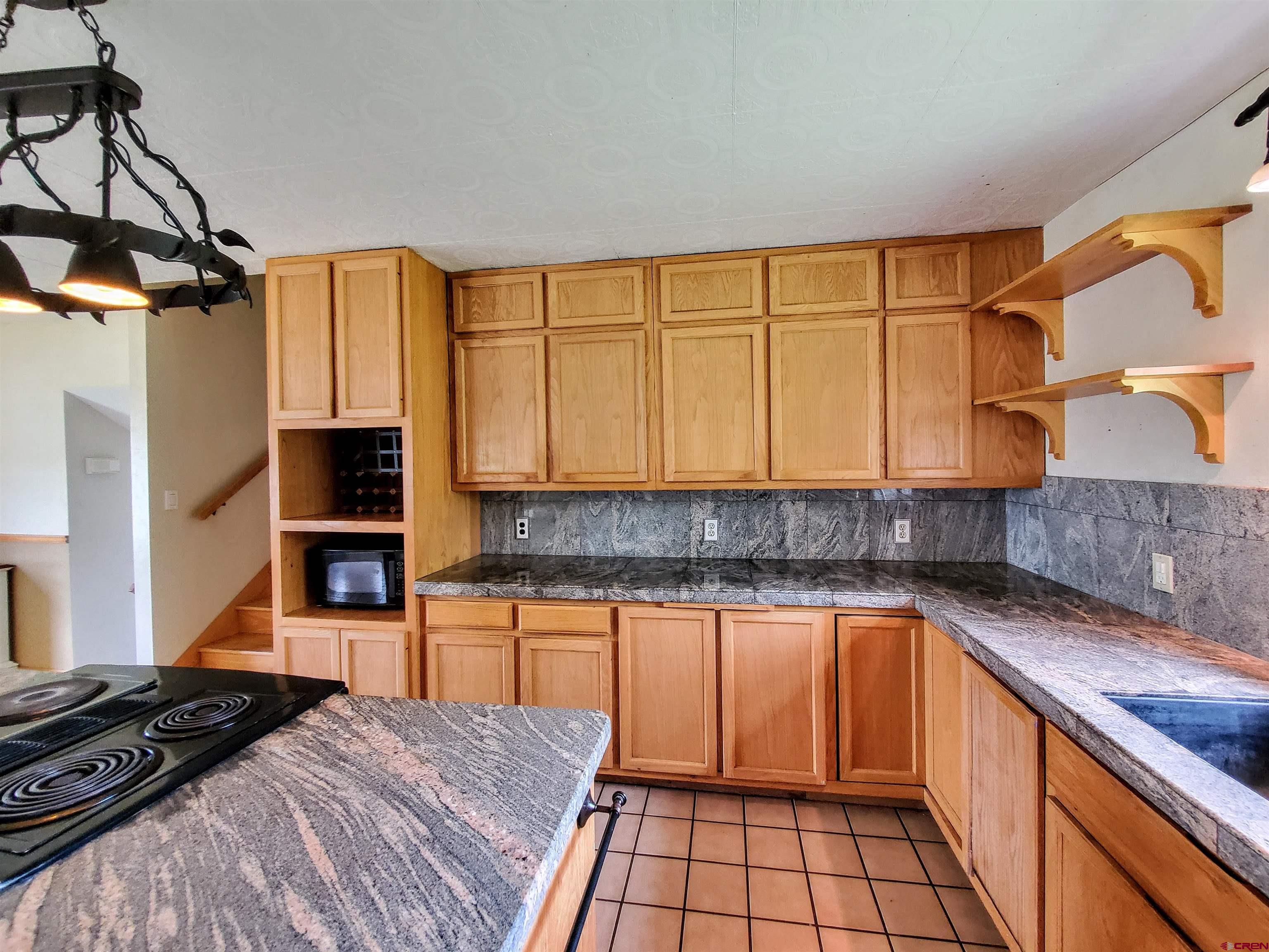 79 Cedar Circle Durango, CO 81303 - Photo 17 of 30 a kitchen with stainless steel appliances granite countertop a sink stove and cabinets