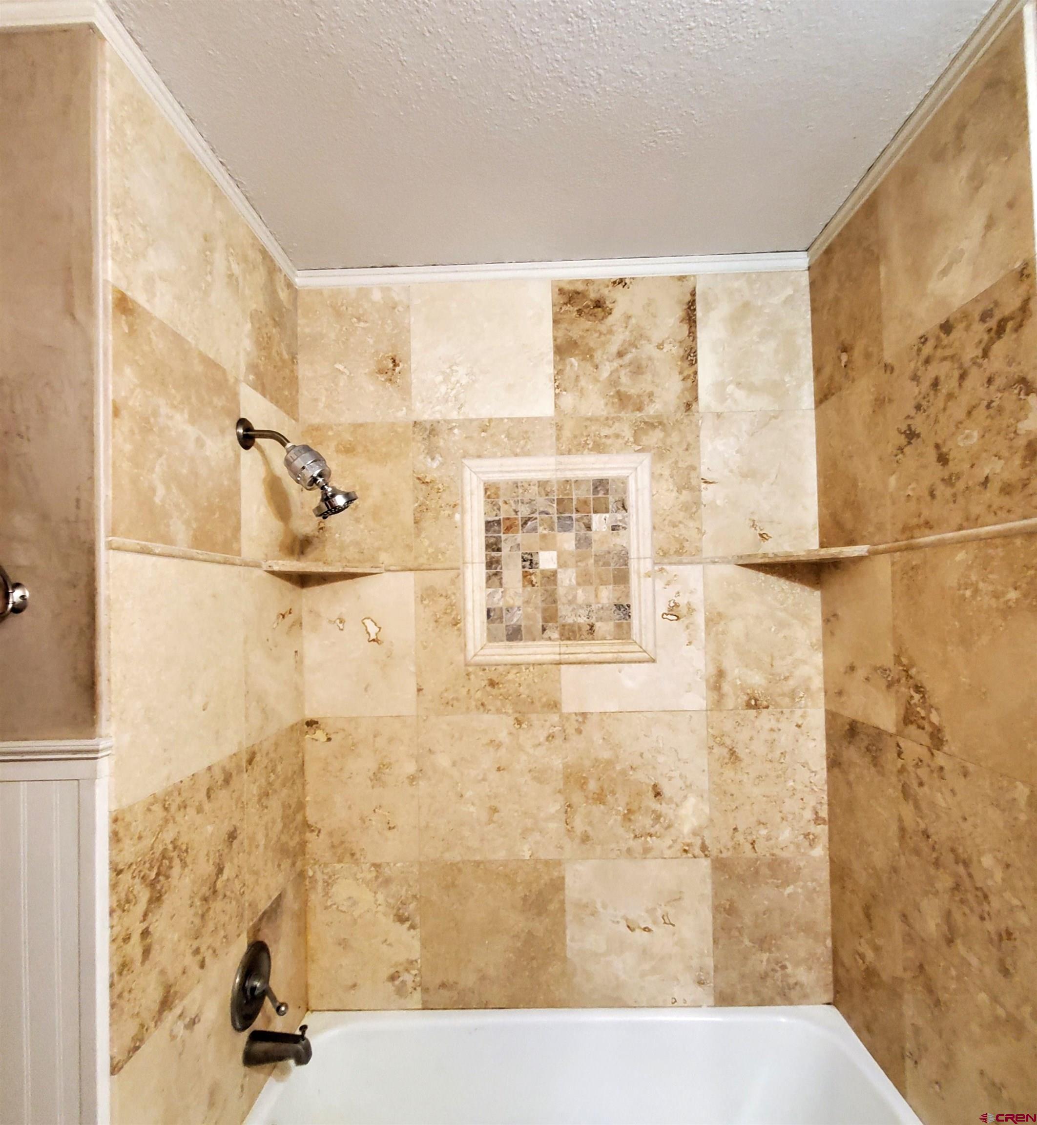 79 Cedar Circle Durango, CO 81303 - Photo 23 of 30 a bathroom with a bathtub and shower