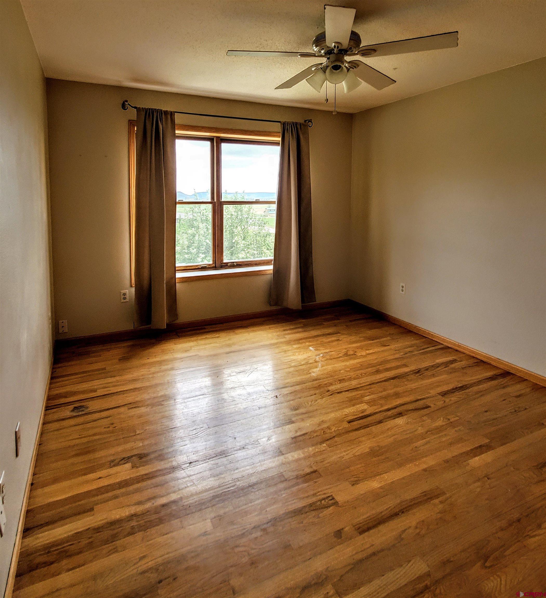79 Cedar Circle Durango, CO 81303 - Photo 26 of 30 wooden floor in an empty room with a window