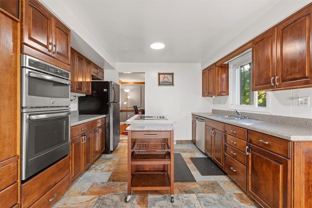 2239 Old Washington Road Pittsburgh, PA 15241 - Photo 16 of 37 a kitchen with stainless steel appliances granite countertop a stove refrigerator and cabinets