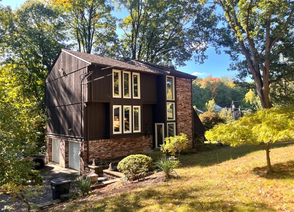 2239 Old Washington Road Pittsburgh, PA 15241 - Photo 2 of 37 a front view of a house with a yard covered with snow and trees