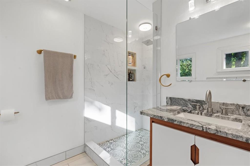2239 Old Washington Road Pittsburgh, PA 15241 - Photo 30 of 37 a bathroom with a granite countertop sink a mirror and shower