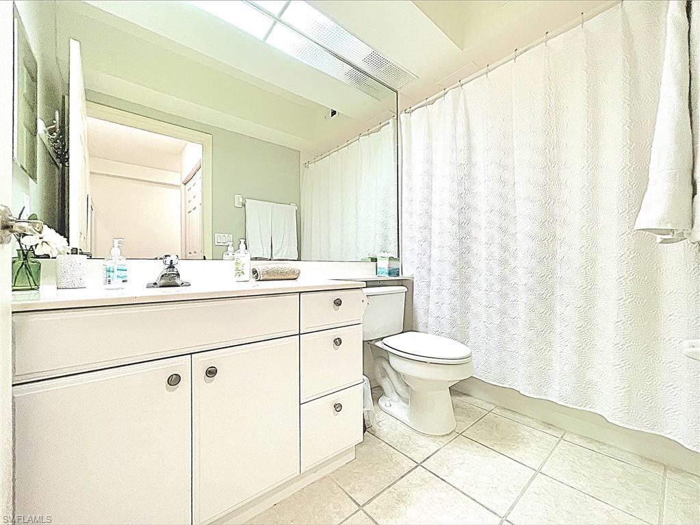 23821 Marbella Bay Road, Unit 102 Estero, FL 34135 - Photo 15 of 30 a bathroom with a toilet sink and a mirror