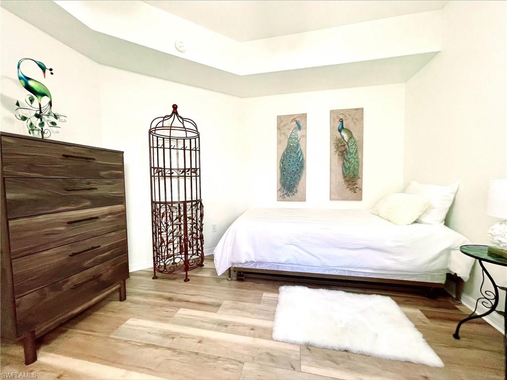 23821 Marbella Bay Road, Unit 102 Estero, FL 34135 - Photo 16 of 30 a bedroom with a bed and a window