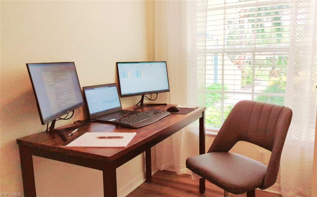 23821 Marbella Bay Road, Unit 102 Estero, FL 34135 - Photo 17 of 30 a view of a workspace with furniture and a window