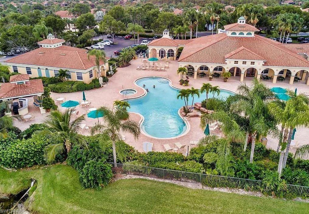 23821 Marbella Bay Road, Unit 102 Estero, FL 34135 - Photo 19 of 30 an aerial view of a house with garden space and lake view