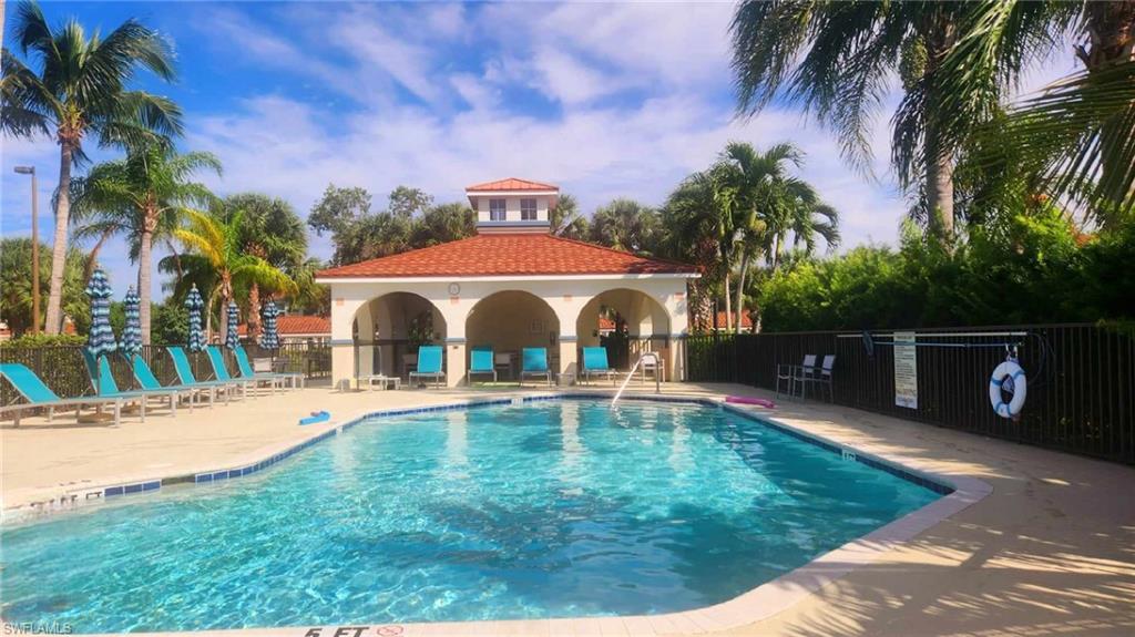 23821 Marbella Bay Road, Unit 102 Estero, FL 34135 - Photo 20 of 30 a front view of a house with swimming pool having outdoor seating