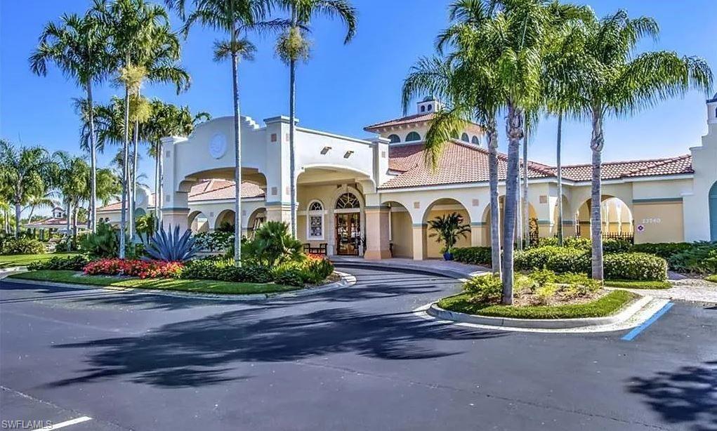 23821 Marbella Bay Road, Unit 102 Estero, FL 34135 - Photo 23 of 30 a front view of a house with yard and green space