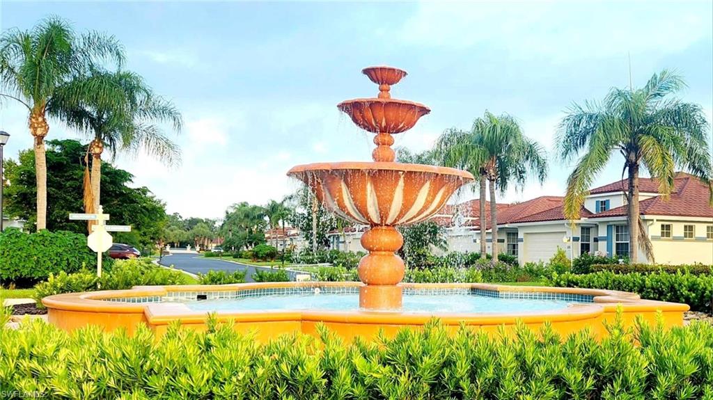 23821 Marbella Bay Road, Unit 102 Estero, FL 34135 - Photo 26 of 30 a view of a swimming pool and a yard