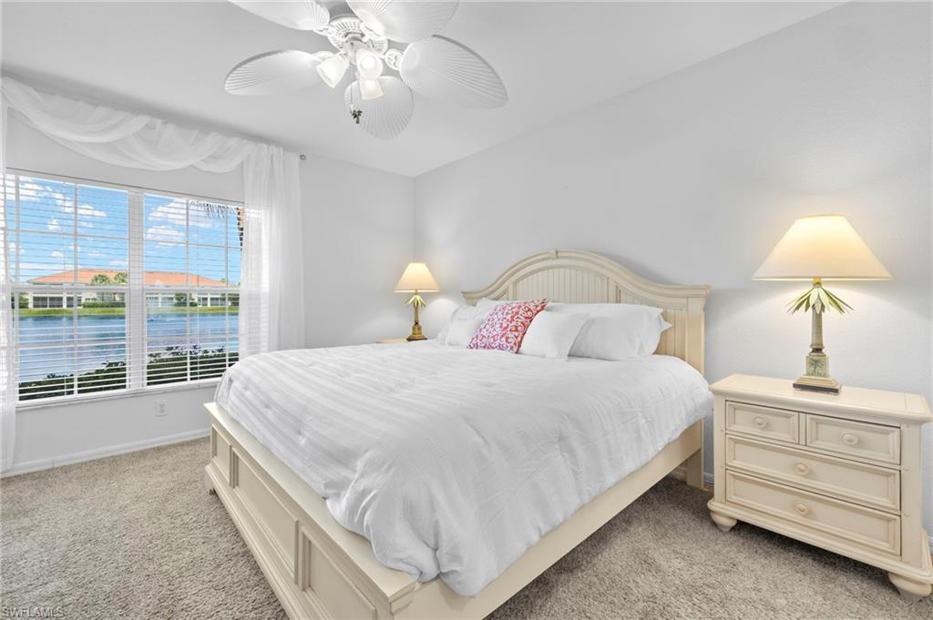 23821 Marbella Bay Road, Unit 102 Estero, FL 34135 - Photo 9 of 30 a bedroom with a bed and a chandelier