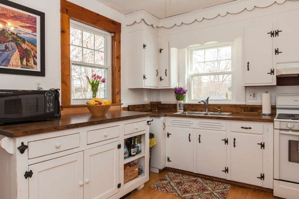 97 Bay State Road Worcester, MA 01606 - Photo 12 of 26 a kitchen with granite countertop white cabinets white appliances and a window