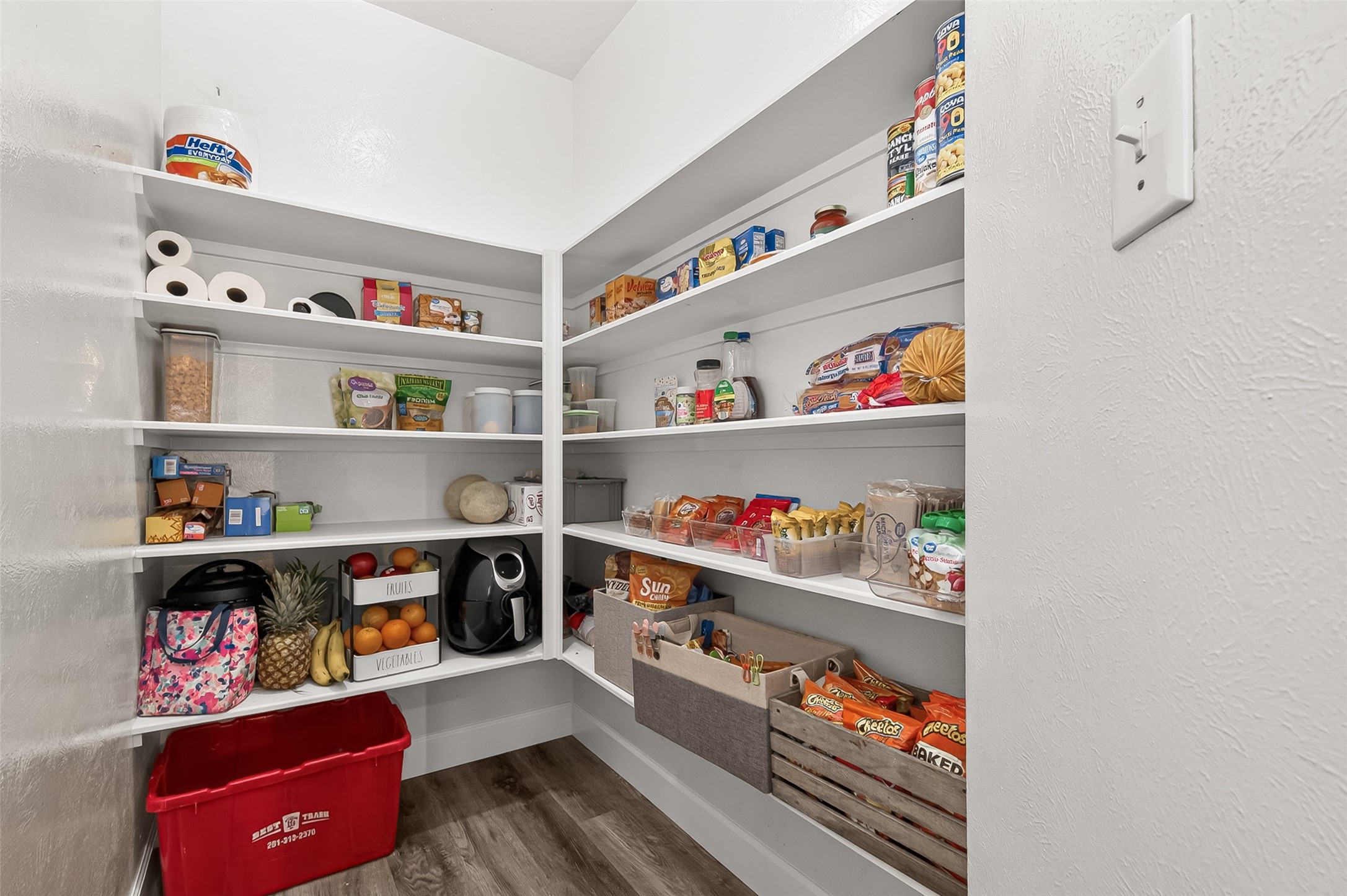 7415 Riven Oaks Court Cypress, TX 77433 - Photo 17 of 42 Spacious walk-in pantry with built-in shelving provides ample storage and organization for groceries, kitchen essentials, and everyday convenience.