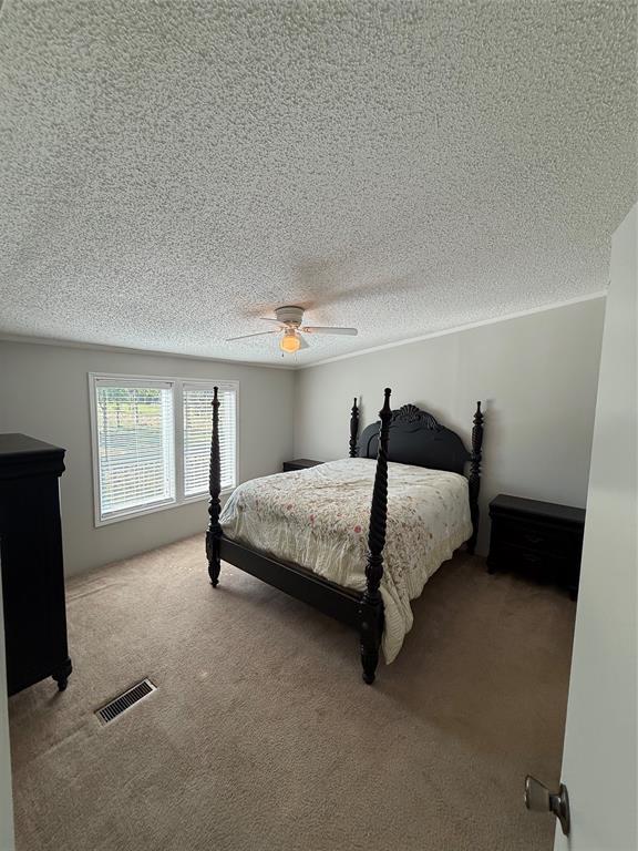 277 Oaks Crossing Road Mineral Wells, TX 76067 - Photo 17 of 25 a bedroom with a bed and a window