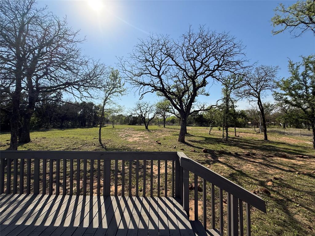 277 Oaks Crossing Road Mineral Wells, TX 76067 - Photo 4 of 25 a view of a yard with wooden fence