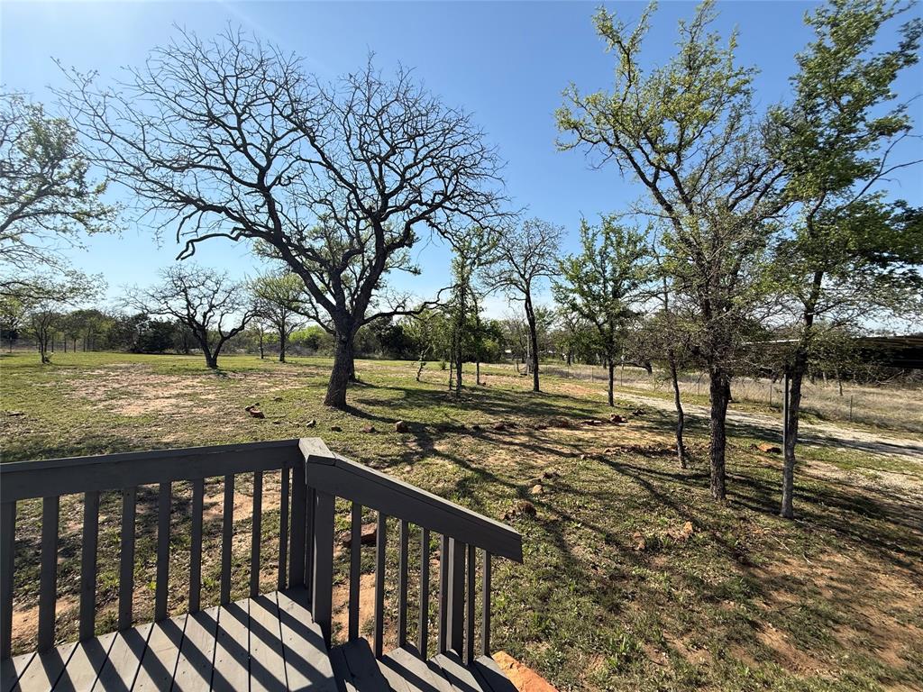 277 Oaks Crossing Road Mineral Wells, TX 76067 - Photo 5 of 25 a view of a yard with wooden fence