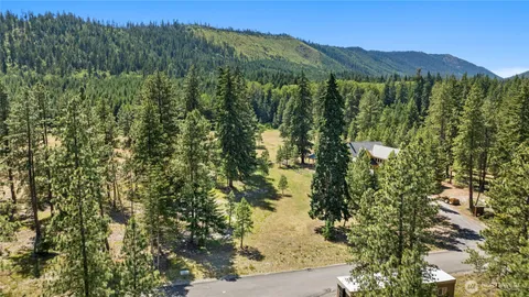 a view of a lush green hillside and a building