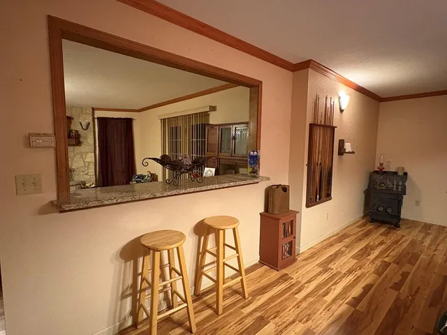 a large kitchen with a table and chairs