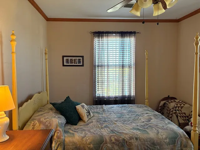 a bedroom with a bed and a window