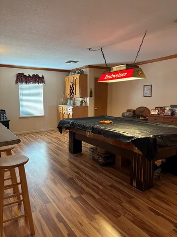 a kitchen view of a stove and a wooden floor