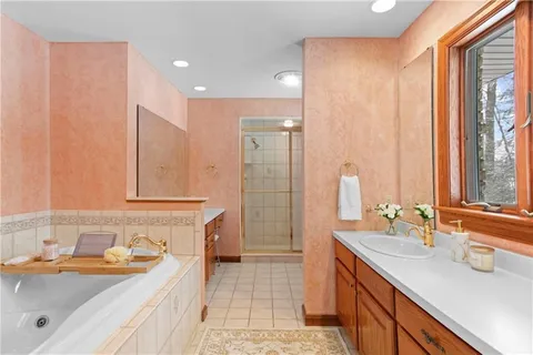 a spacious bathroom with a granite countertop sink and a mirror