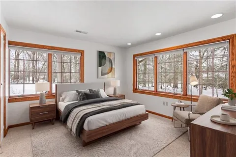 a bedroom with bed and a large window