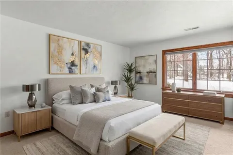 a bedroom with a large bed and a window