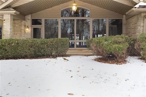 a view of white house with a snow on the road