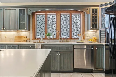 a kitchen with a window a sink and a counter top space
